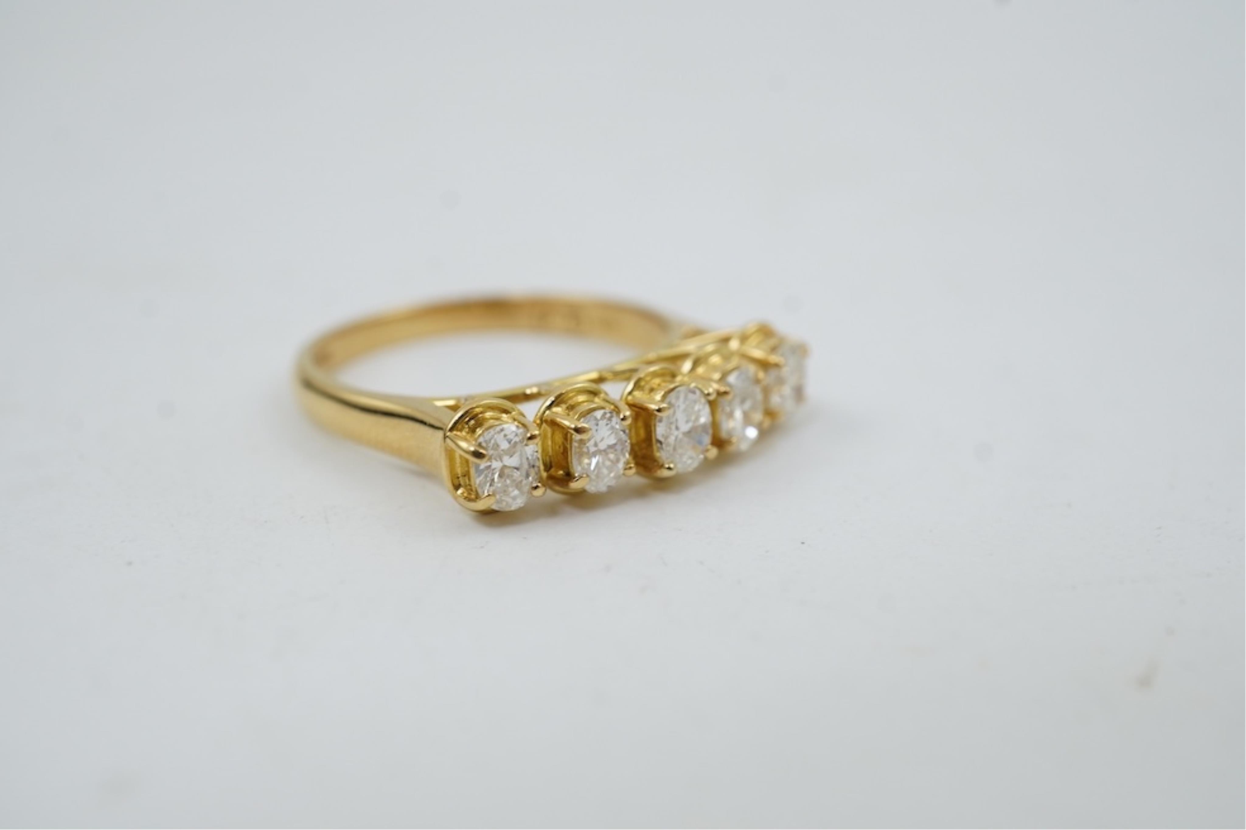 A modern 18ct gold and five stone oval cut diamond set half hoop ring, size N, gross weight 3.8 grams.